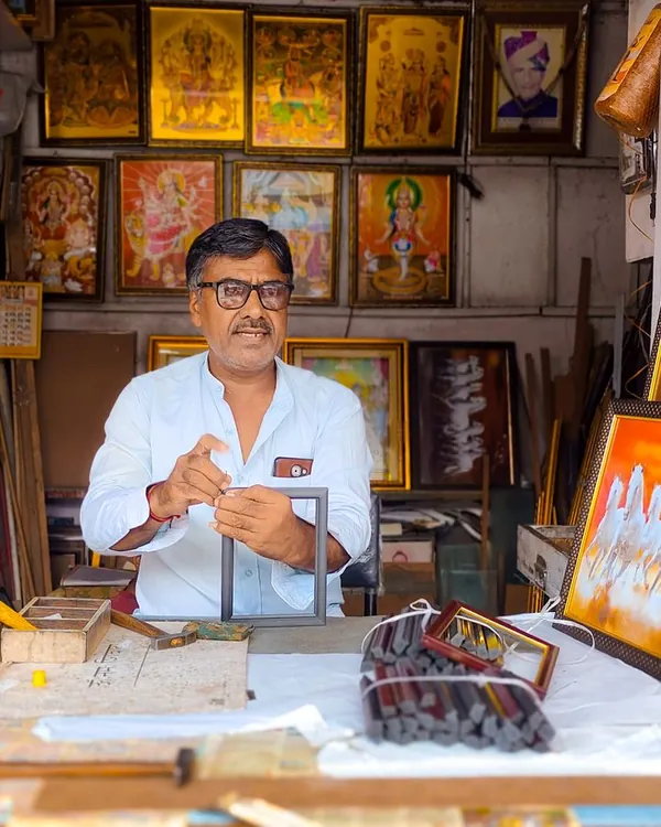 A framing shop owner among his frames