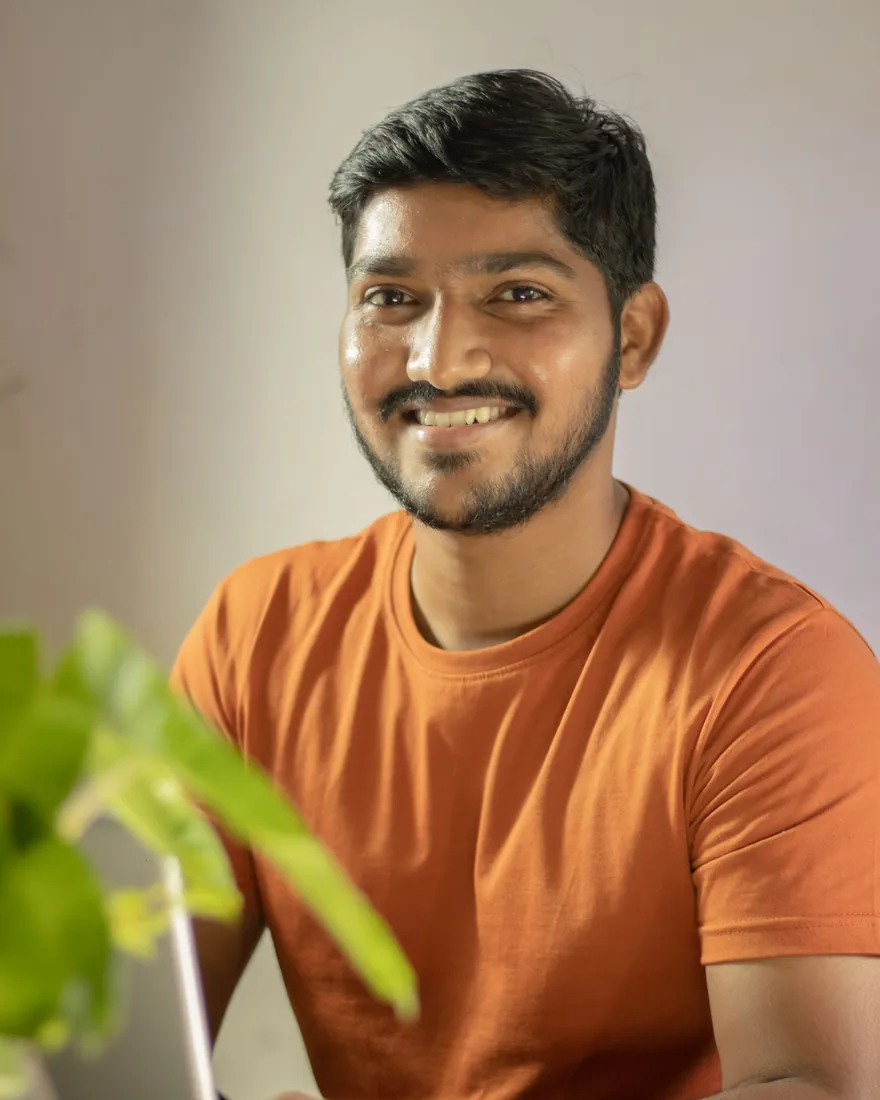 A smiling small-business owner at his laptop
