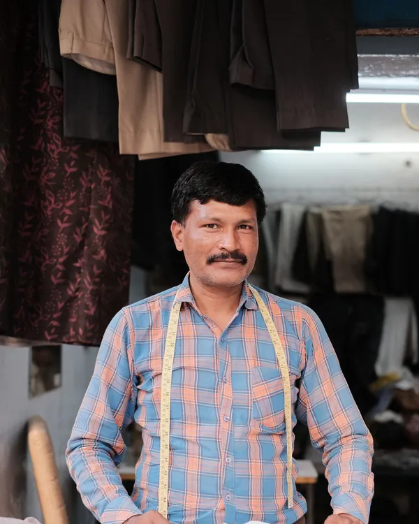 A tailor standing at his cutting table